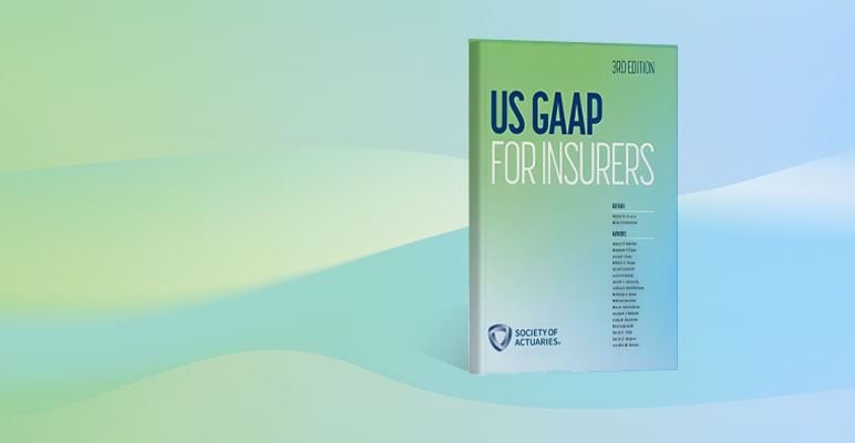 Photograph of man standing in front of three people sitting at desks with laptops while he is pointing at a bar graph on a large screen.