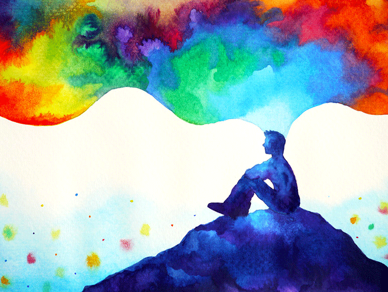 Photograph of middle-aged male facing camera, sitting in living room holding and reading a piece of paper.